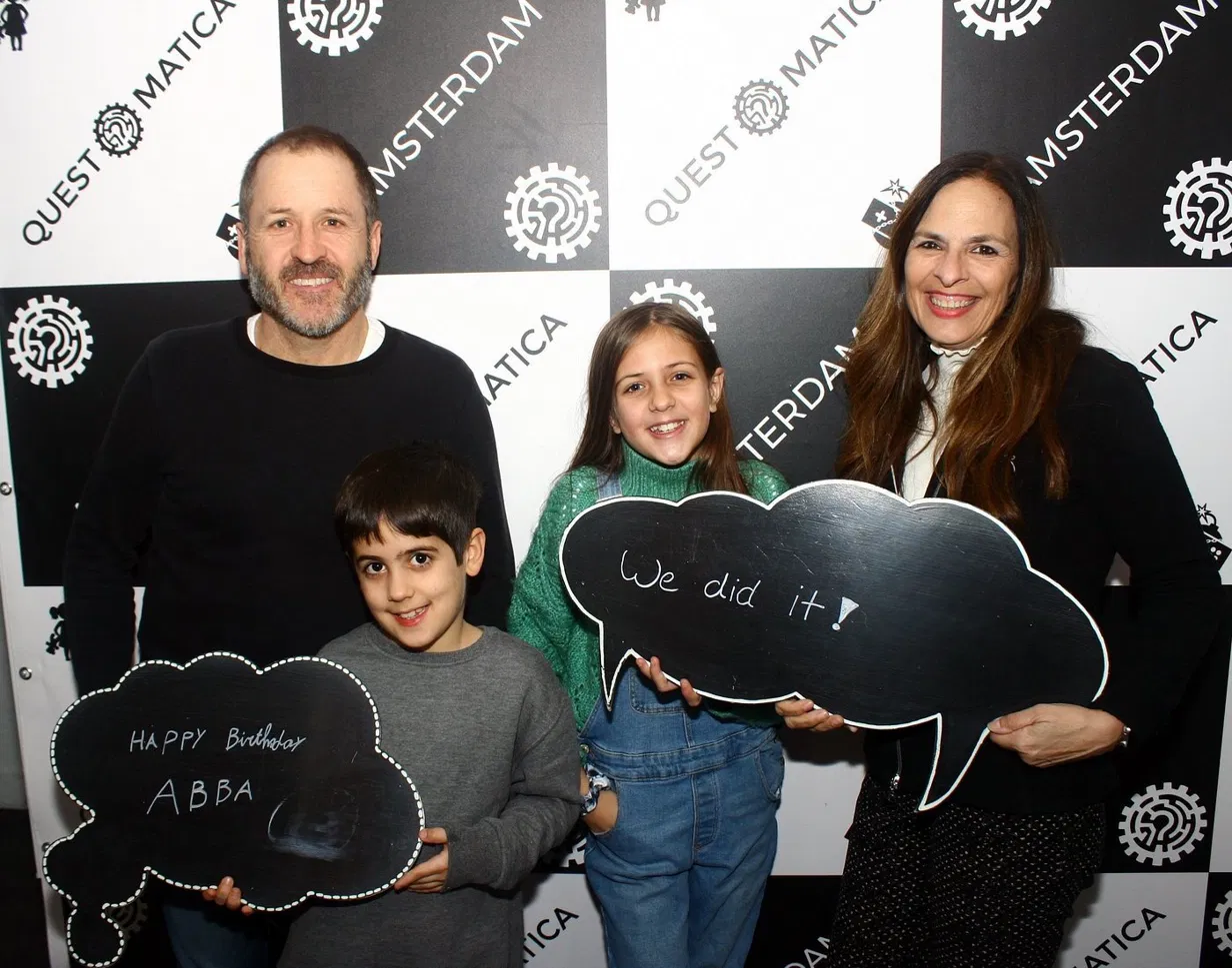 Family celebrating after completing escape room at Questomatica Amsterdam